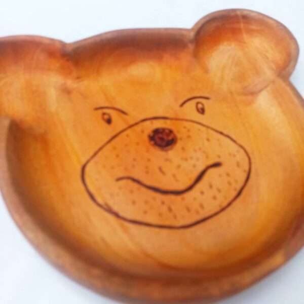 Wood kids plate in brown color made like a bear face to make eating more interesting